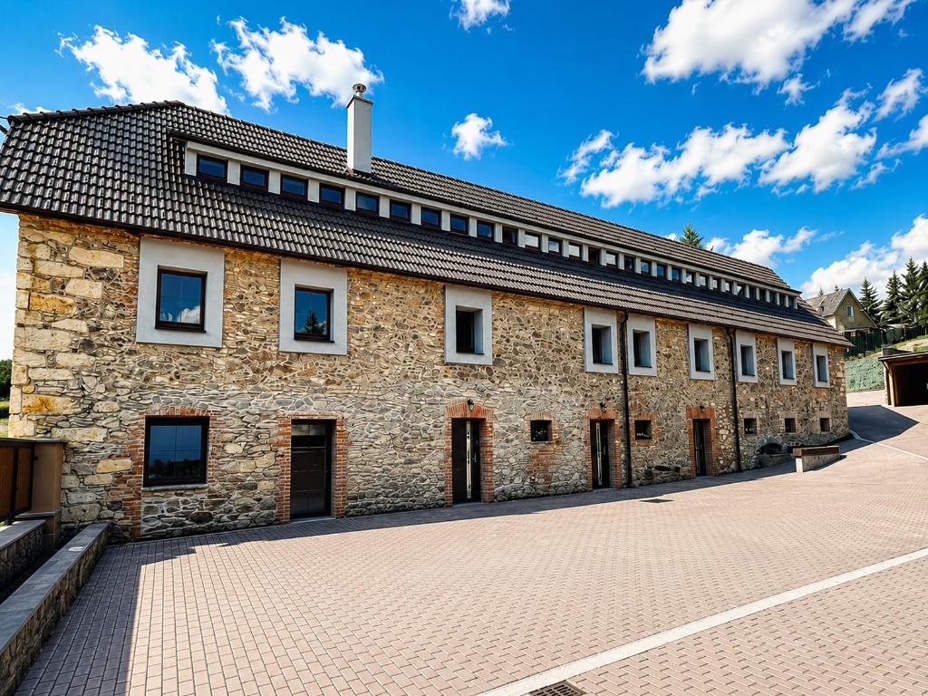 a large brick building with a roof at Apartmány Haberschie in Řehlovice