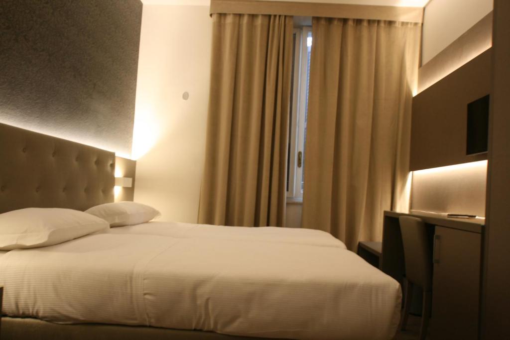 Postel nebo postele na pokoji v ubytování Hotel Principe