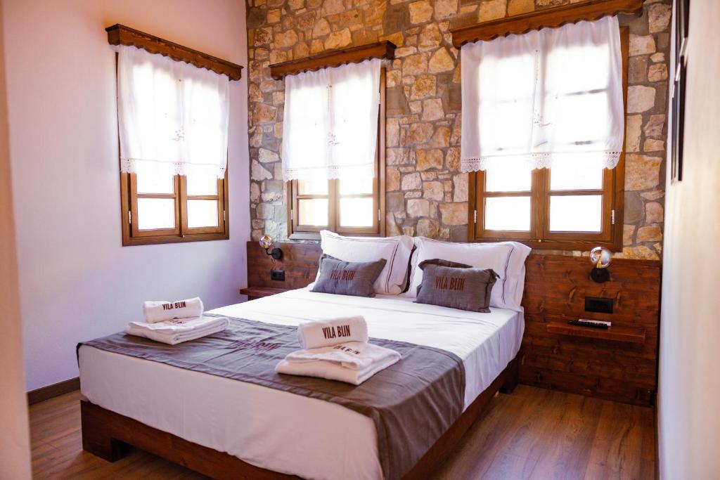 a bedroom with a large bed with two towels on it at Vila Blin in Berat