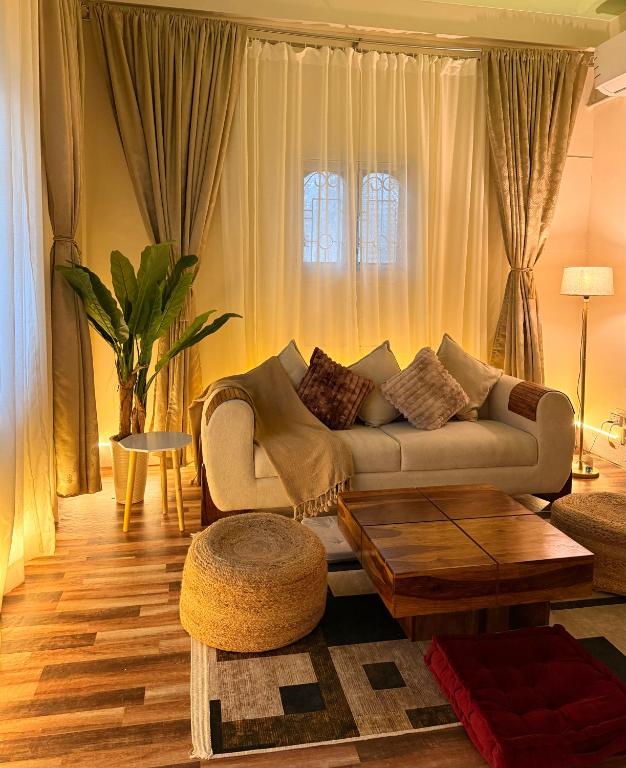 a living room with a couch and a table at Sunshine Stays in Siliguri