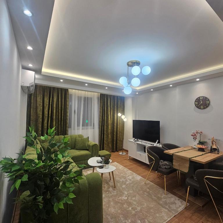 a living room with a green couch and a table at Stan na dan Bijeljina centar 2 in Bijeljina