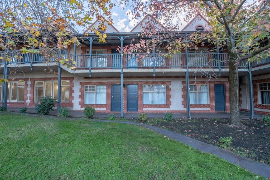 an apartment building with a balcony and a yard at St Francis Winery in Old Reynella