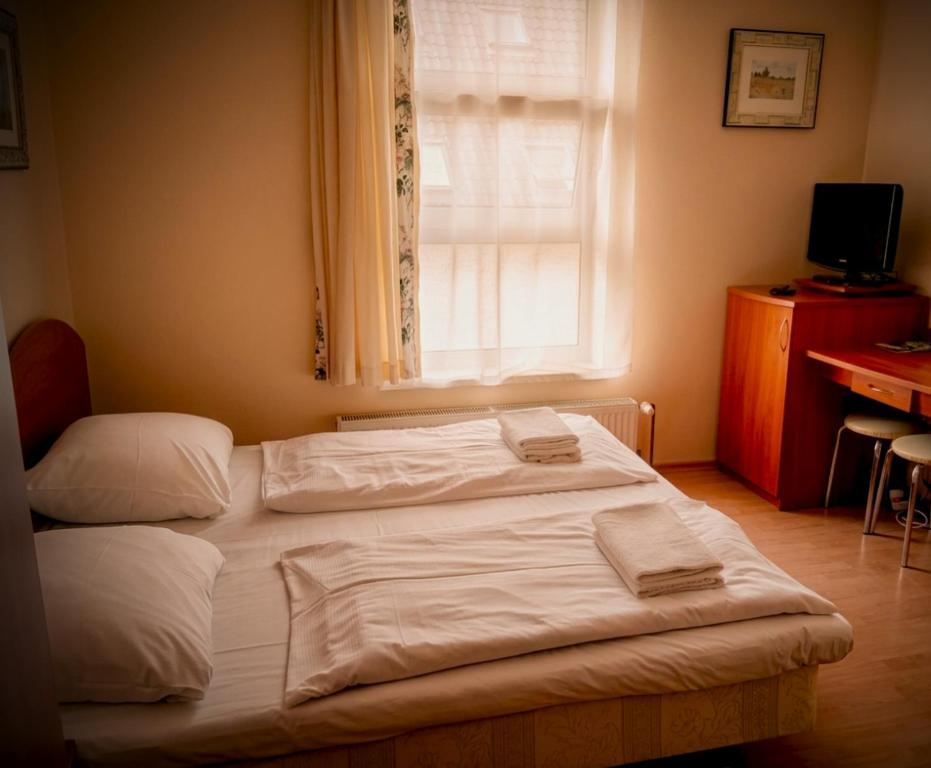 a bed with two towels on it in a bedroom at Villa Aqua in Międzyzdroje