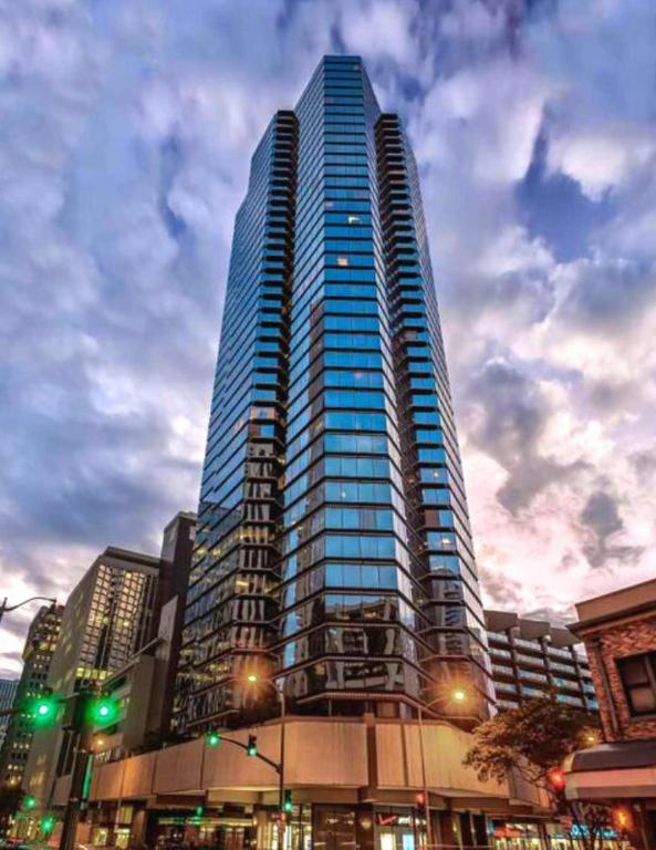 a tall skyscraper in a city at Executive Center Hotel Honolulu in Honolulu