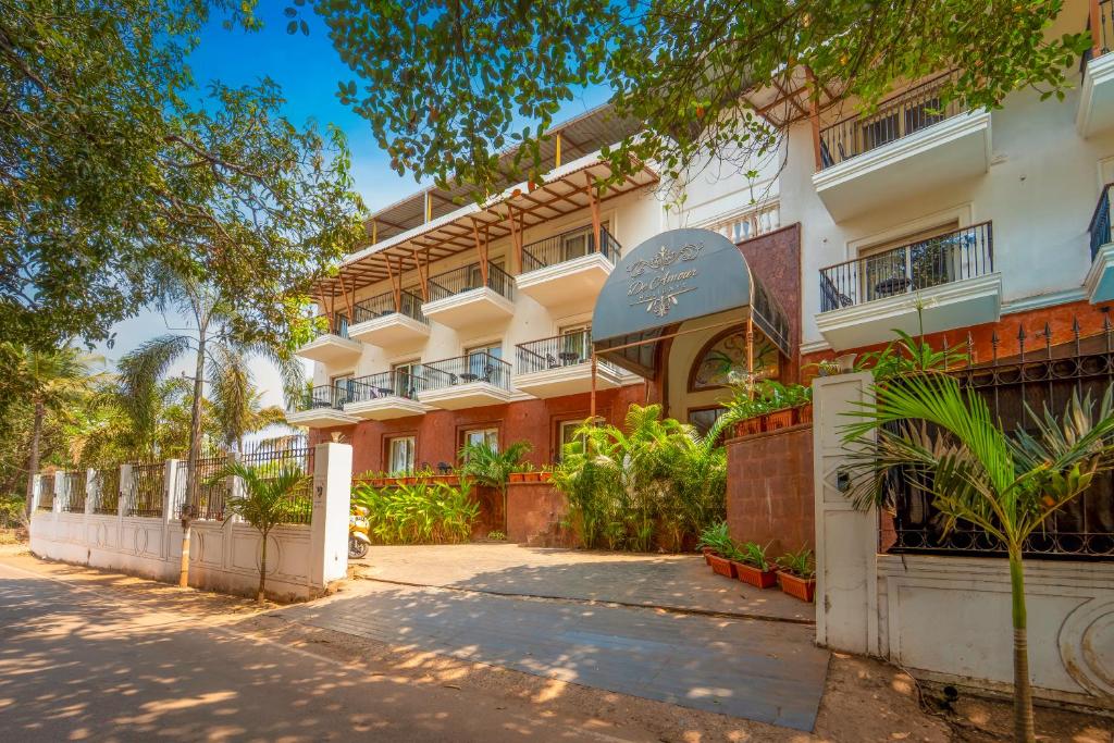 a large white building with trees in front of it at De Amour - A Dreamy Getaway in Anjuna in Anjuna