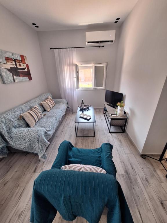a living room with a couch and a table at VILLA HAWAii in Nea Moudania