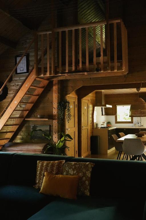 a living room with a staircase in a house at Het Leendernest in Leende