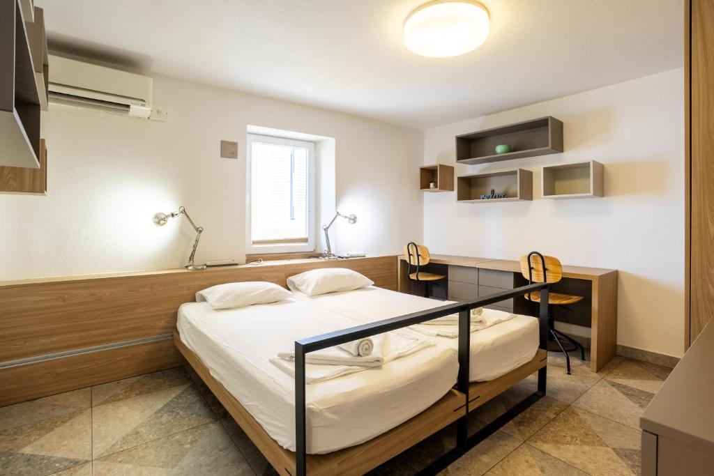 a hospital room with a bed and a desk at Casa Riccobon 5 in Koper