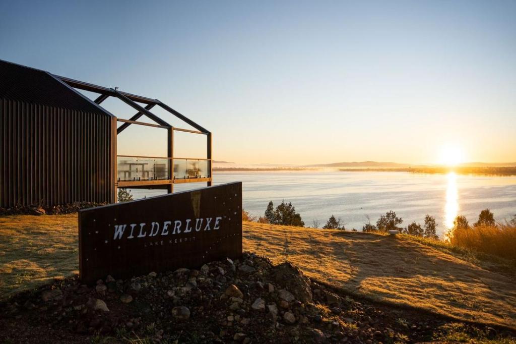 a sign in front of a body of water at Wilderluxe Lake Keepit in Keepit
