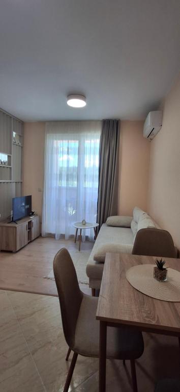 a living room with a bed and a table at Sea&Sunset Studio in Sozopol