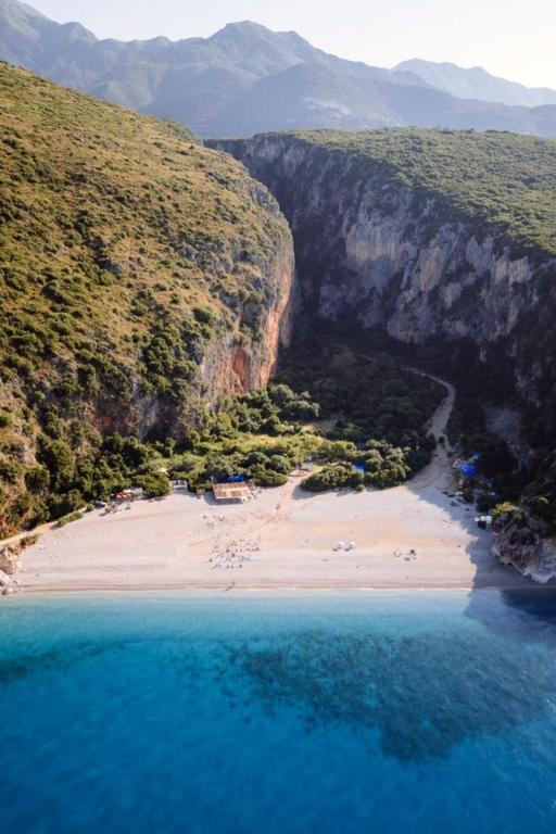 an aerial view of a beach with people on it at Gjipe eco campground 2 in Ilias