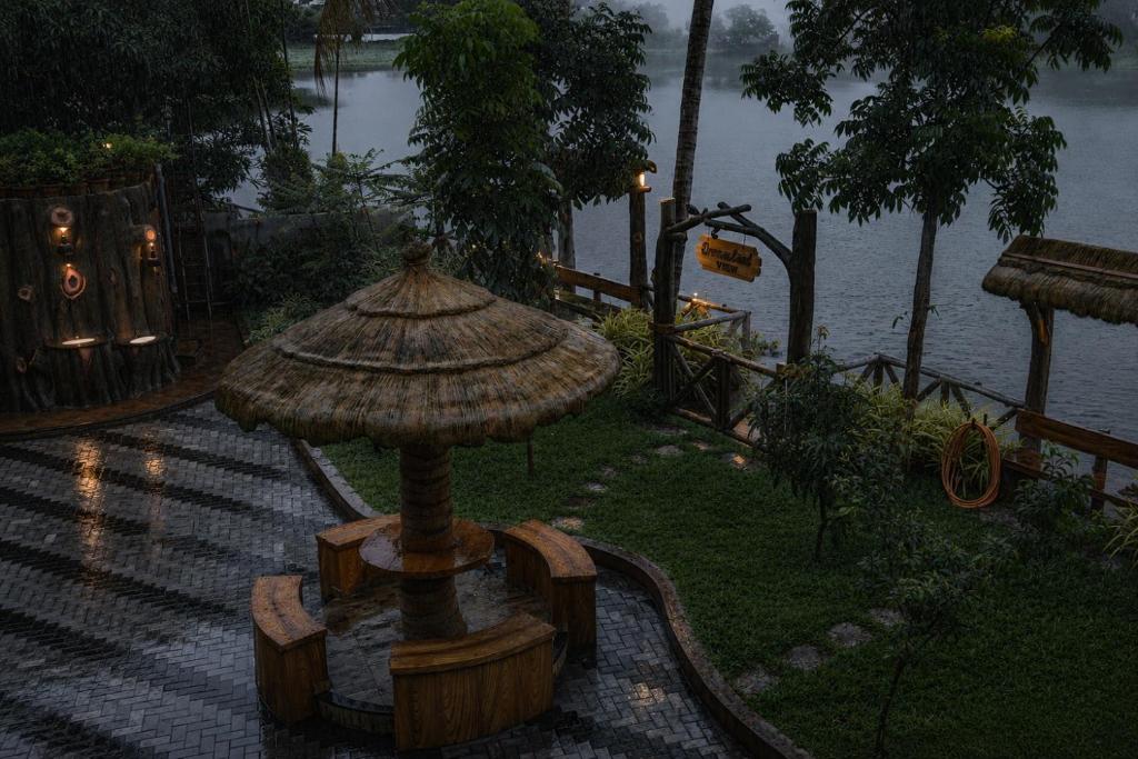 a large umbrella in a park near the water at Dreamland View Resort in Cochin