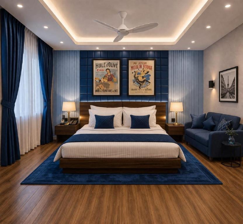 a bedroom with a large bed and a couch at Hotel La Casa Near Delhi Airport in New Delhi