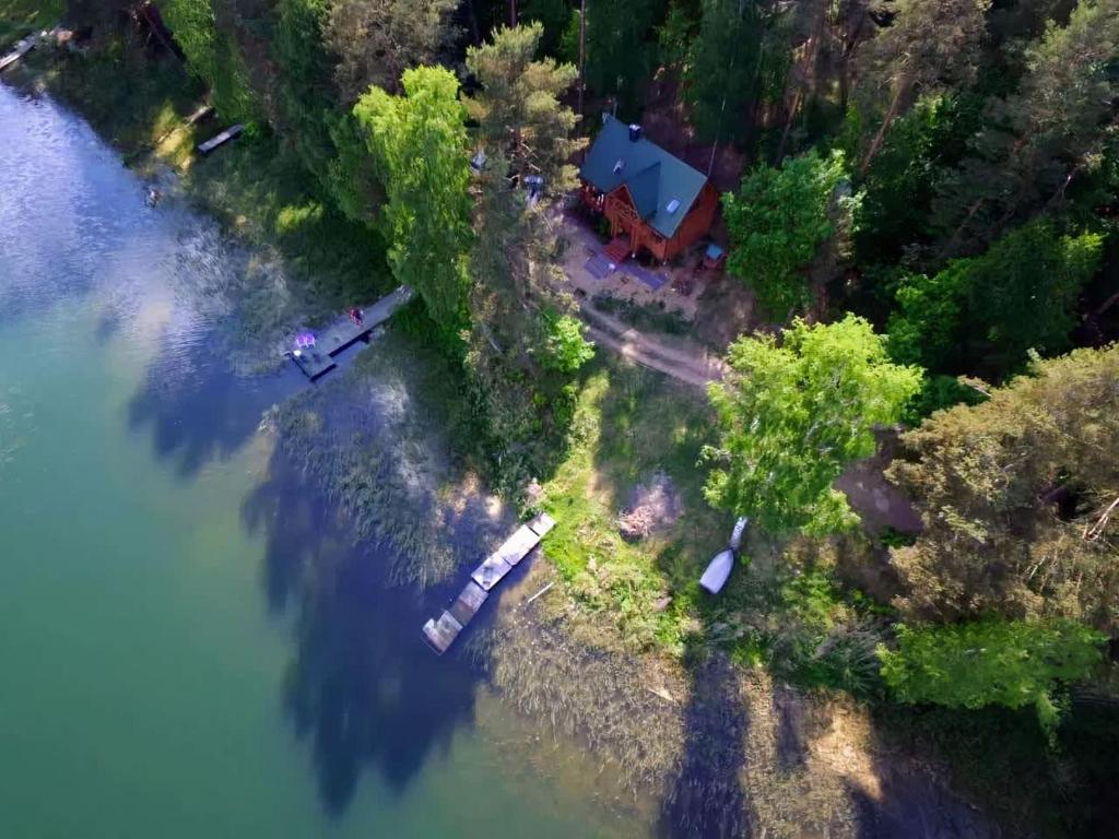 an aerial view of a house next to the water at Przystanek Jezioro - Kaszuby in Studzienice