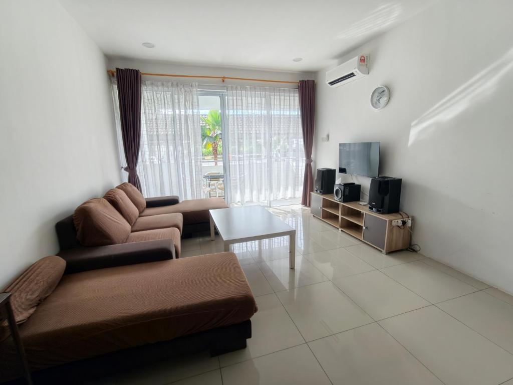 a living room with a couch and a table at Homelite Resort in Miri