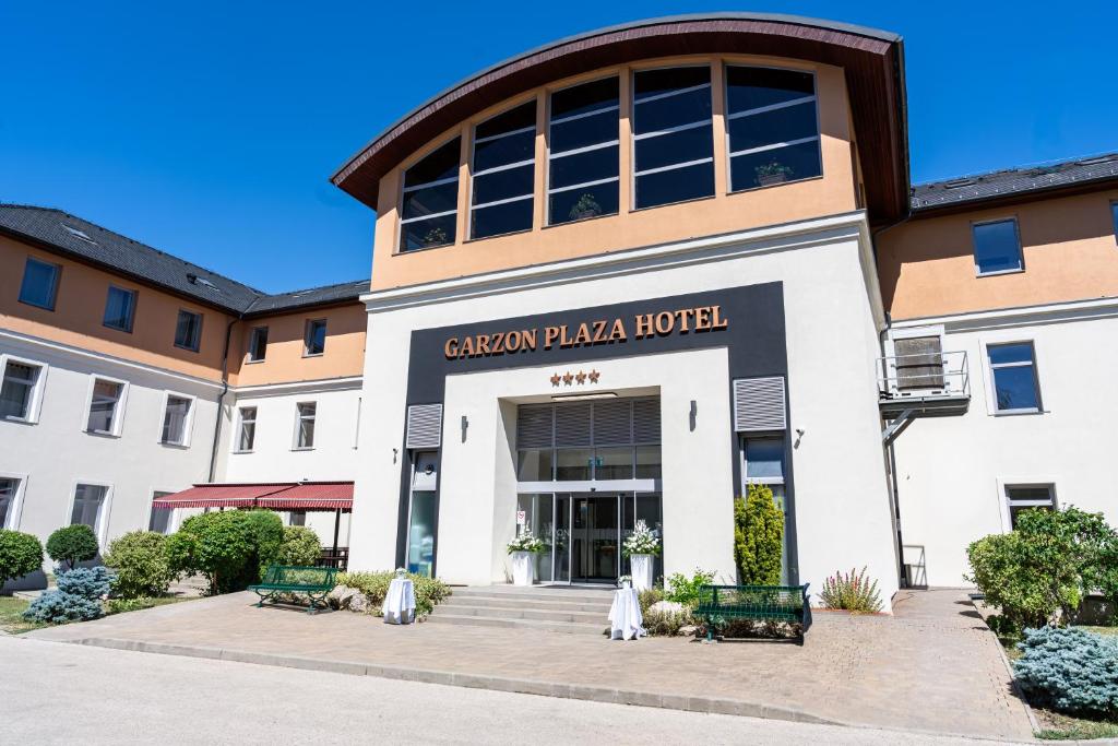a building with a sign that reads citizen plaza hotel at Hotel Garzon Plaza in Győr