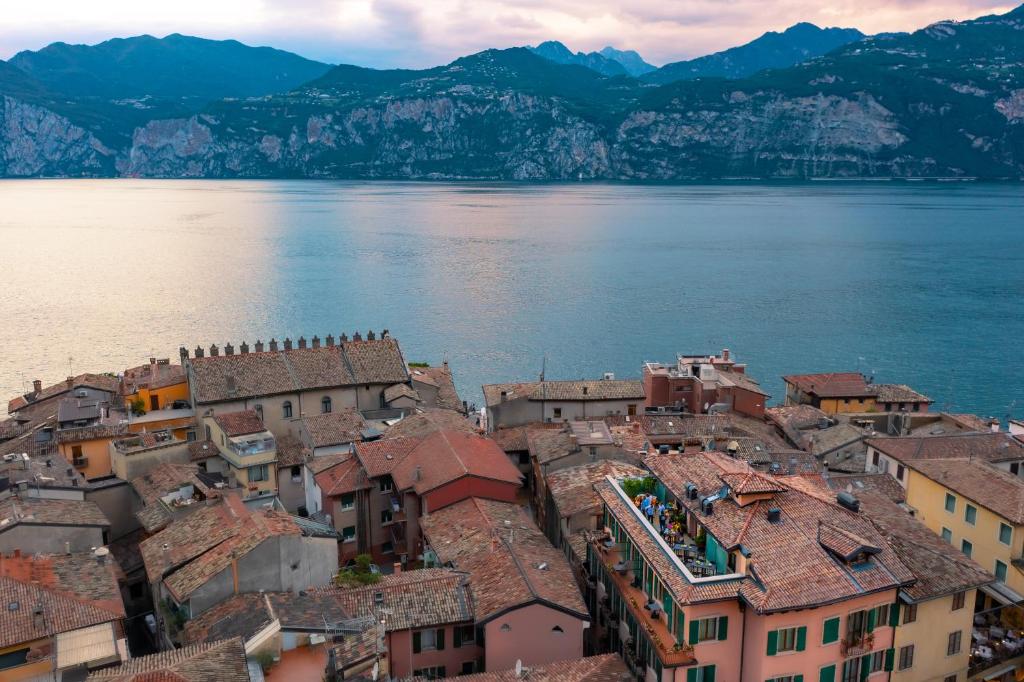 an aerial view of a town next to a body of water at Hotel Lago Di Garda in Malcesine