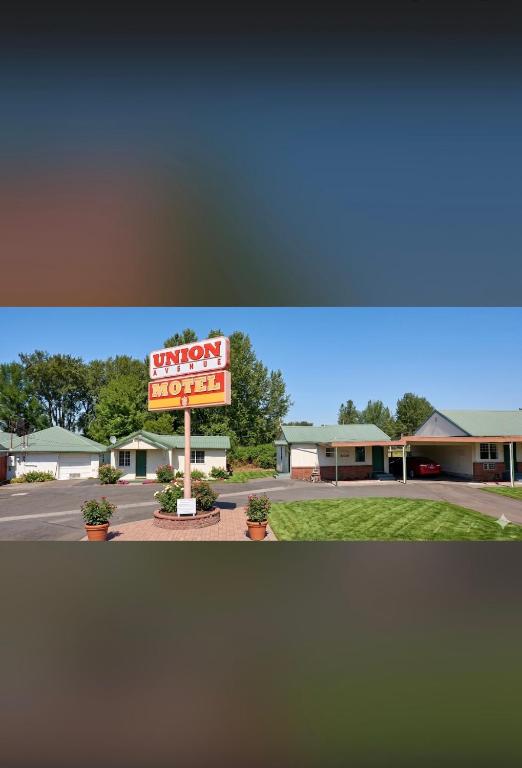 a sign for a hotel with a sign for a tavern at Union Avenue Motel in Portland
