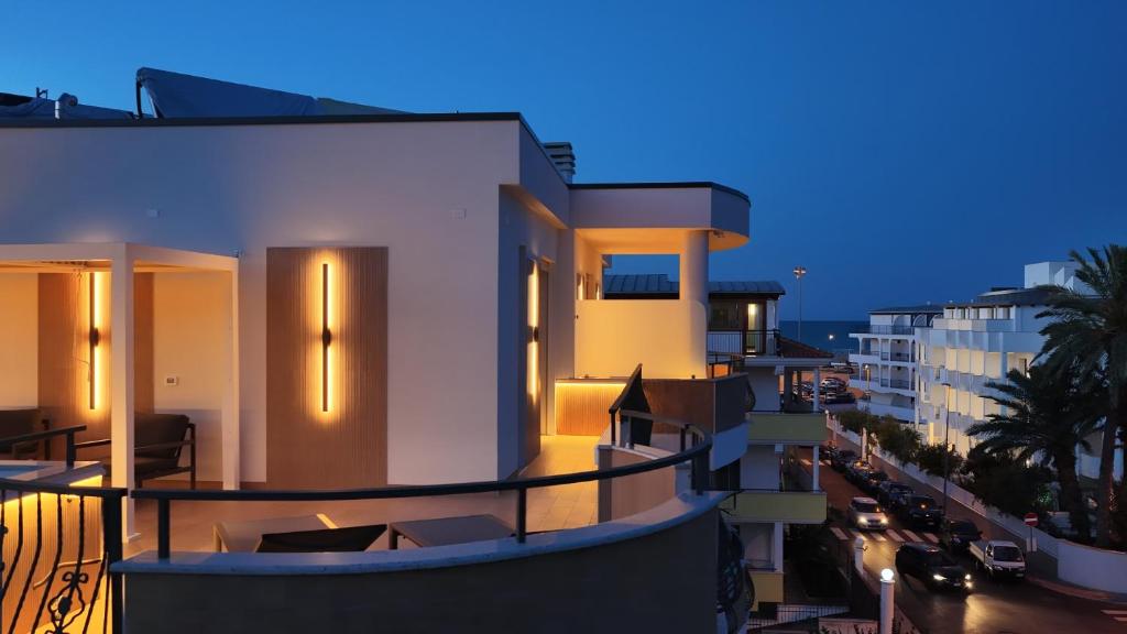 a view of a building from a balcony at night at Manoli Luxury Rooms in Vieste