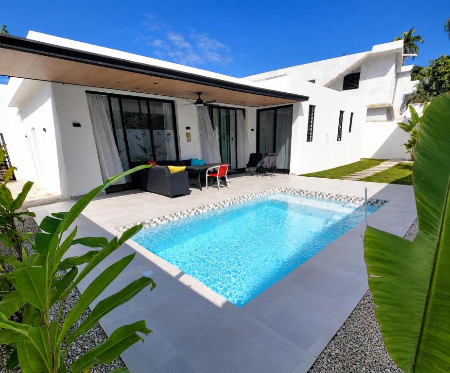 a swimming pool in the backyard of a house at Villa La Vida Dulce Private Pool Near Playa Dorada in Puerto Plata