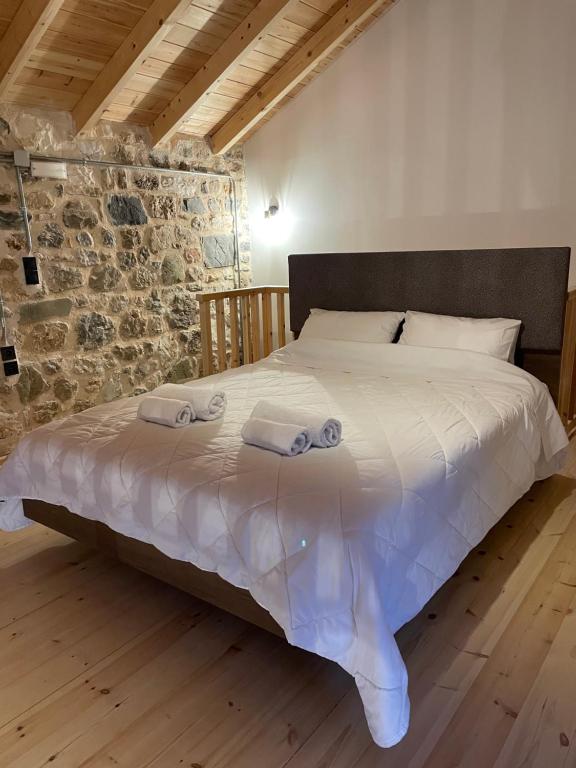 a bedroom with a bed with two towels on it at Mesovouni Stone Suites 1 in Mesovounion-Zagori