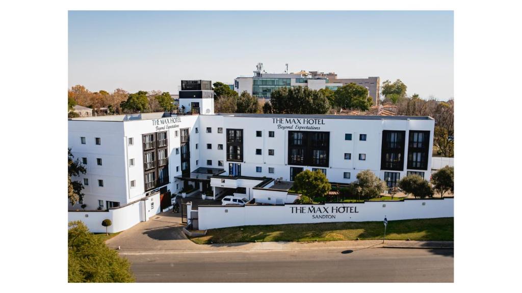 a white building with a sign that reads the inn roll at The Max Hotel Sandton in Johannesburg