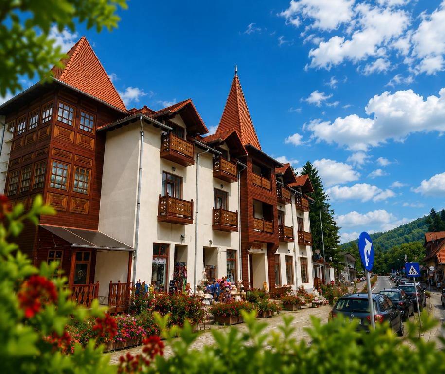a building with a lot of windows and roofs at Muskatli Villa in Sovata