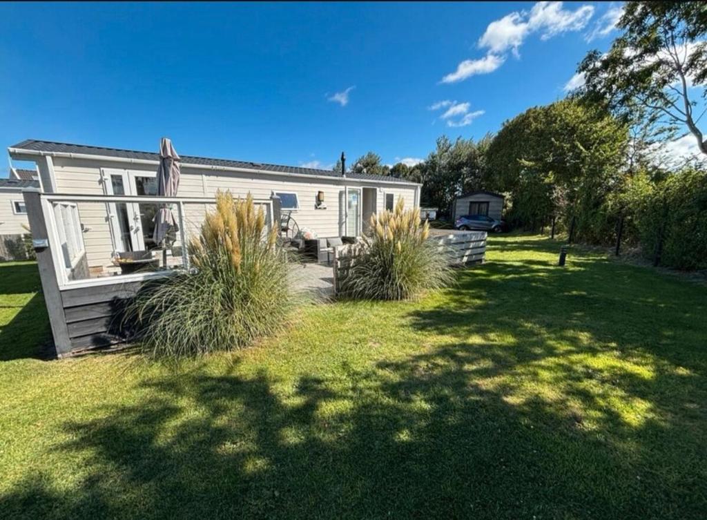 a house with a lawn in front of it at SimpleStayHolland in Westerland
