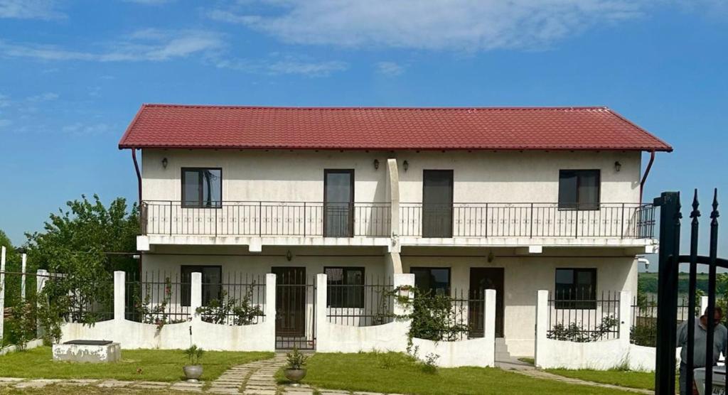 a large white house with a red roof at Villa Tasaul in Năvodari