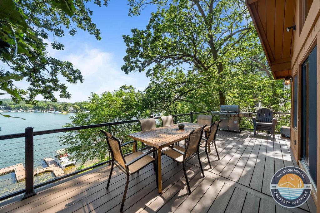 a deck with a table and chairs and a view of the water at 405 Waldeck Dr in Twin Lakes