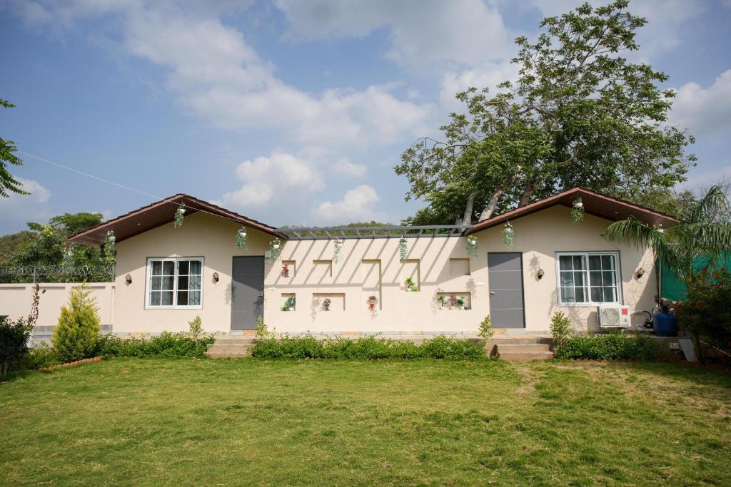 a house with a lawn in front of it at Kunwarsa villa in Udaipur