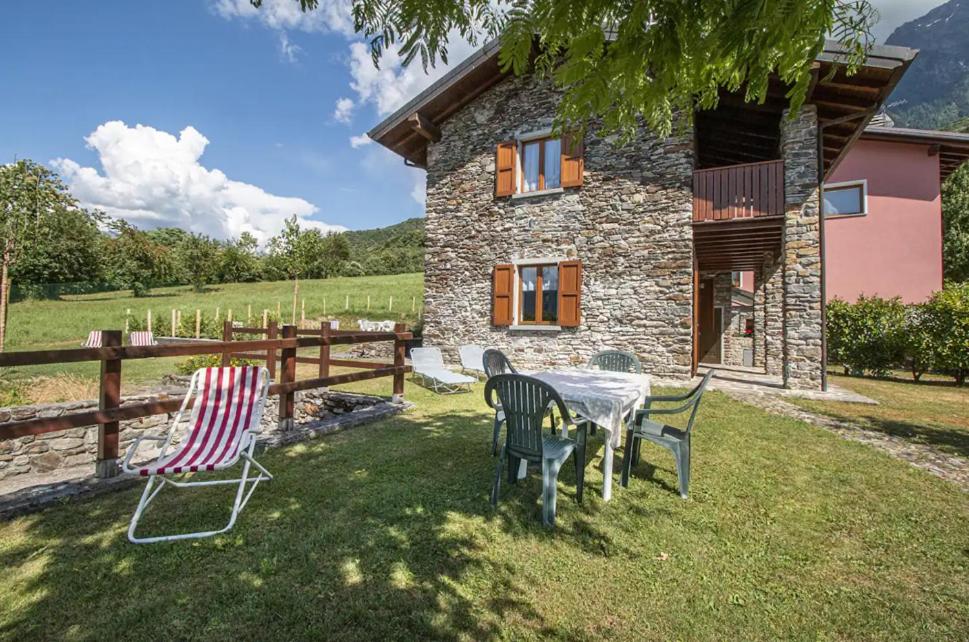 a table and chairs in front of a house at Fausta Lago in Colico