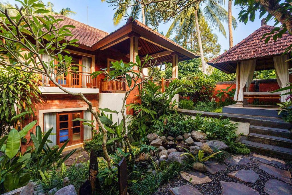 a house with a garden in front of it at Rama Phala Resort & Spa in Ubud