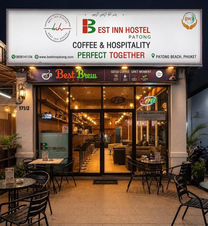 a restaurant with tables and chairs in front of it at Best Inn Hostel and Café Patong Beach in Patong Beach