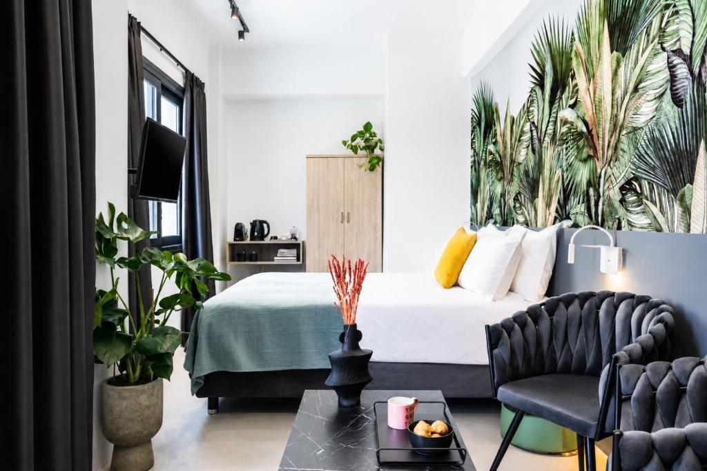 a bedroom with a bed with plants on the wall at PAME Wild in Athens