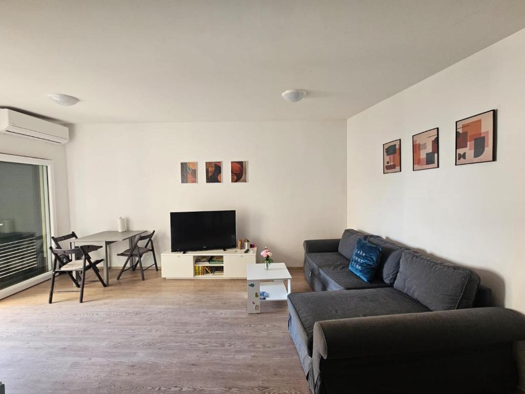 a living room with a couch and a table at Take it slow in Postira
