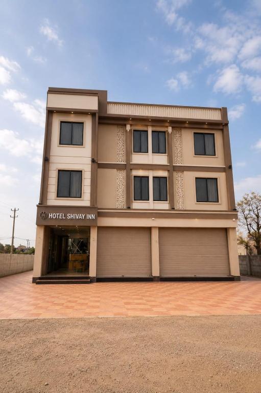 a building with a hotel showroom at Hotel shivay inn in Indore