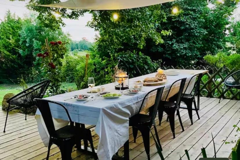 a table with a white table cloth on a deck at Havre de paix in Péreuil