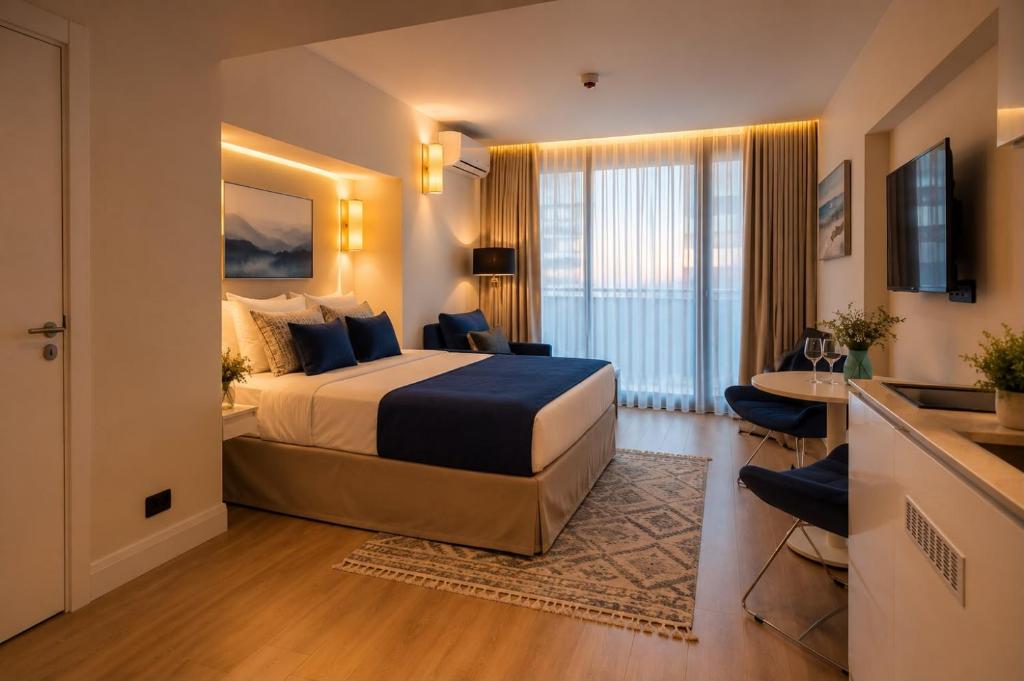 a hotel room with a large bed and a desk at Seaside Studio at Orbi City in Batumi
