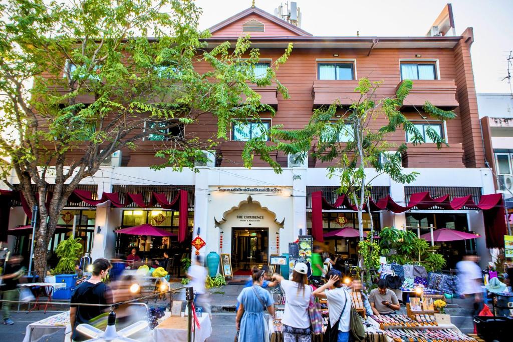 a group of people walking in front of a building at The Experience Walking Street Chiang Mai in Chiang Mai
