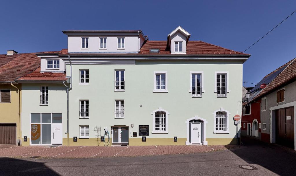 a large white building with a red roof at Kenzingen Appartements zur Alten Brauerei in Kenzingen