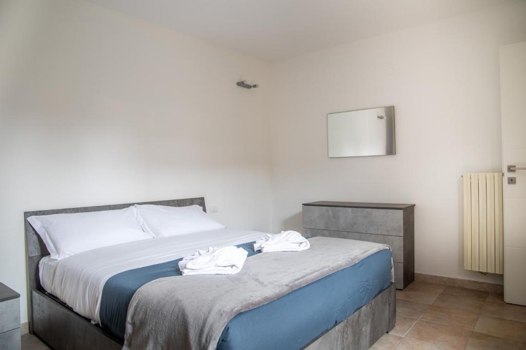 a bedroom with a bed with two towels on it at Humanitas - Leo Brothers - Leopardi 1 in Basiglio