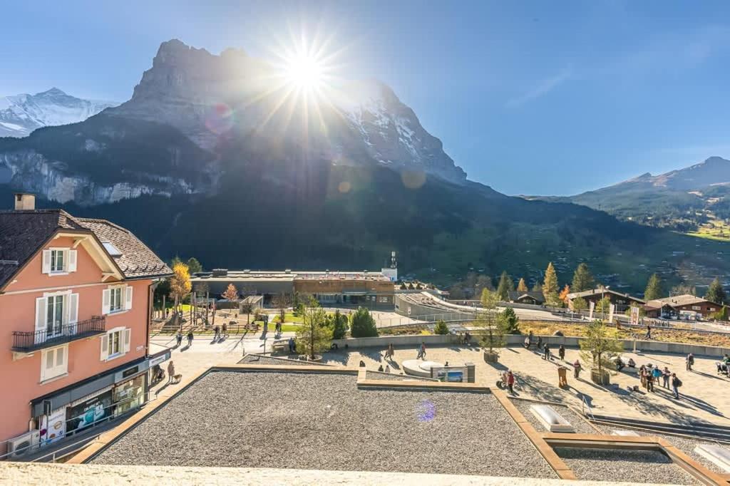 a view of a town with a mountain in the background at Alpin Chic - Aare Jungfrau AG in Grindelwald