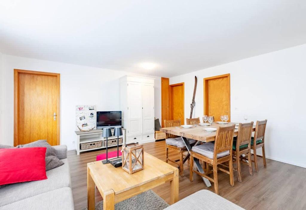 a living room with a table and a couch at Schwabhorn in Axalp