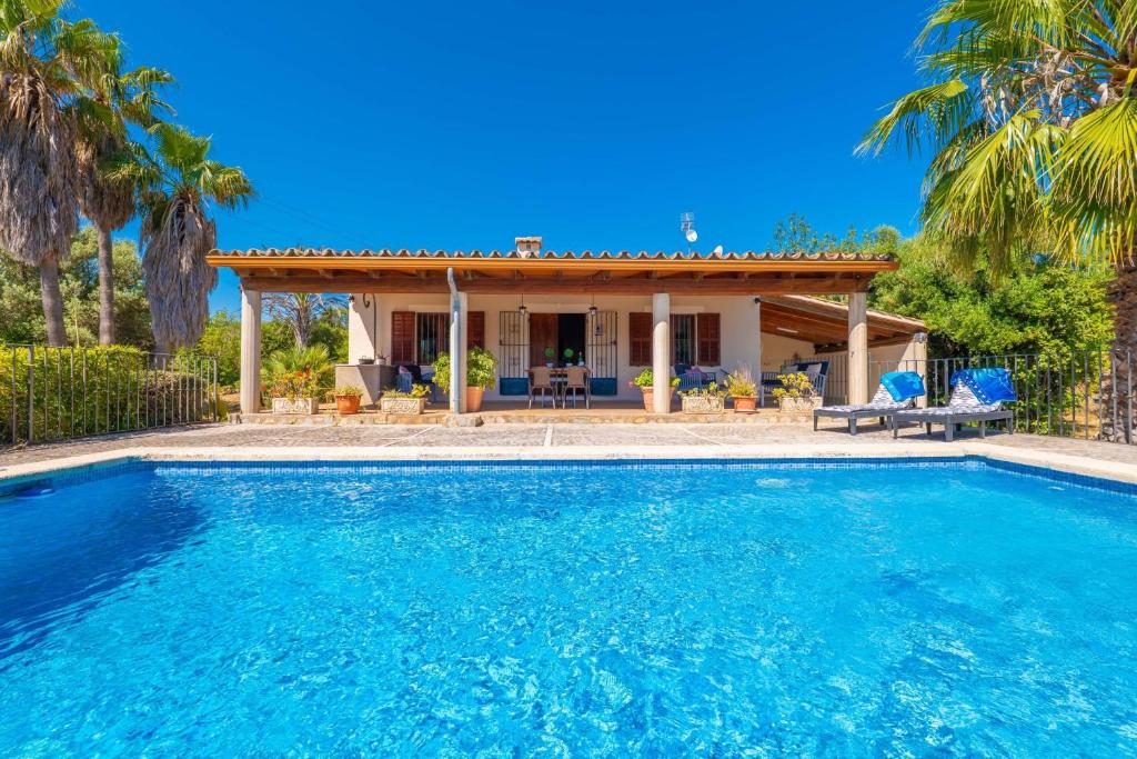 a swimming pool in front of a house at Can Gallu - Adults Only. in Moscari