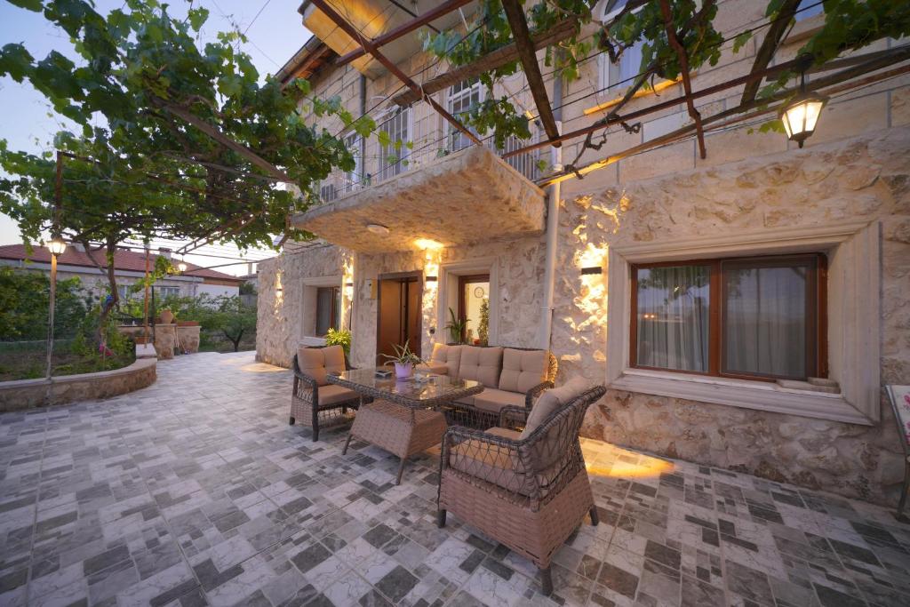 a patio with chairs and a table in front of a building at Diamond Village Ortahisar in Ürgüp