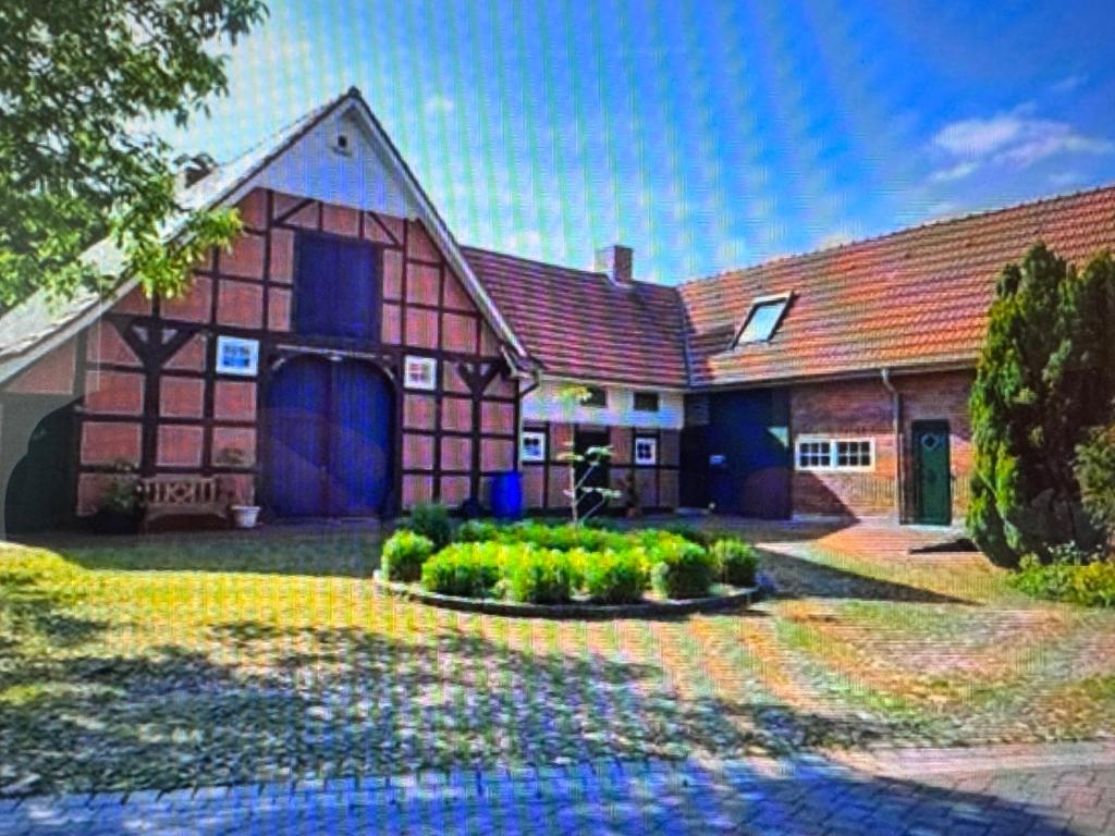 a large house with a yard with a driveway at Kramerhof in Groß Fredenbeck