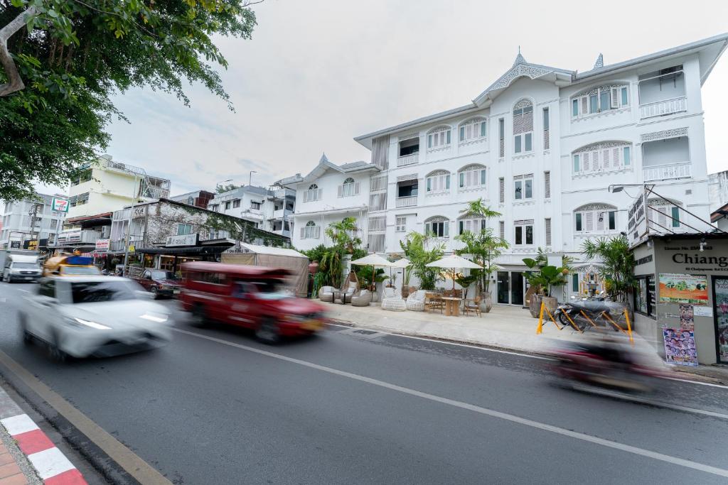 a busy city street with cars and buildings at Nidhra Lanna Hotel Chiang Mai in Chiang Mai