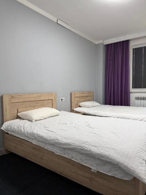 a bedroom with two beds and a window at 名宿 395 Hostel in Bishkek
