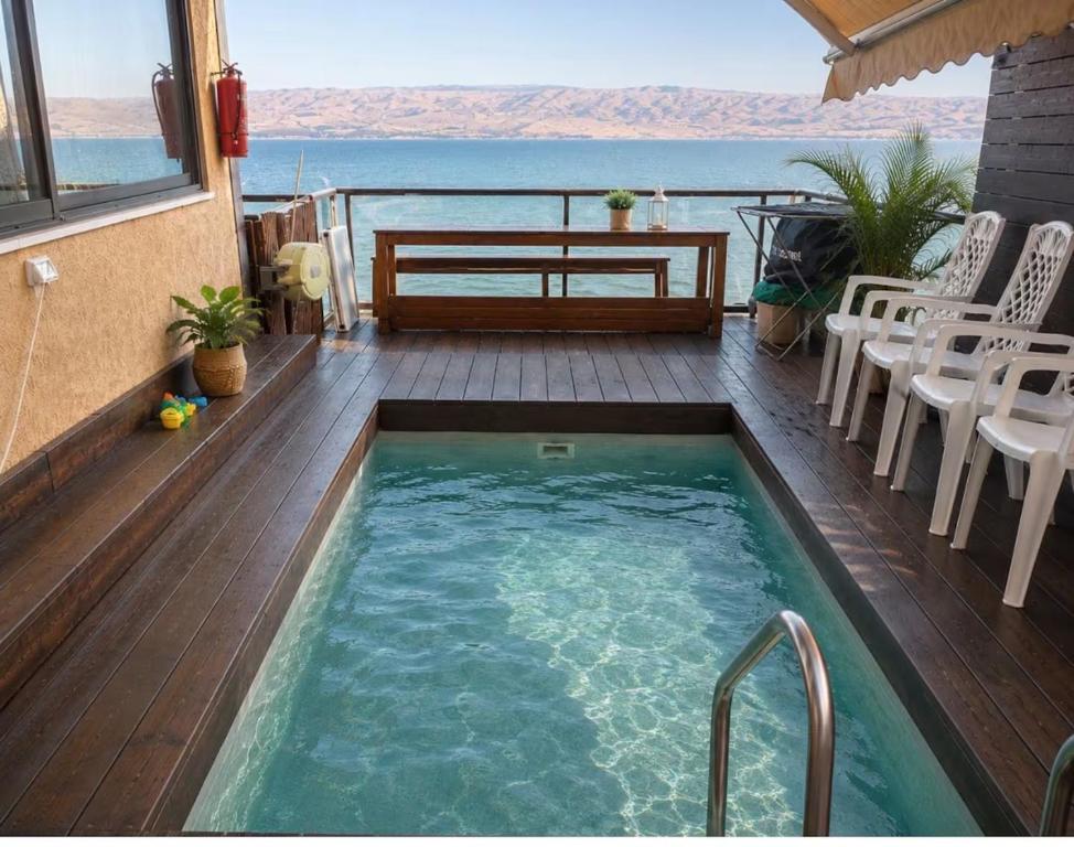 a swimming pool on a deck with a view of the ocean at Dream House Tiberias in Tiberias